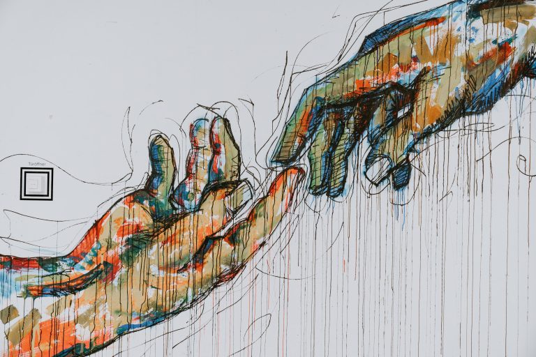 A drawing of two hands touching fingertip to fingertip (Claudio Schwarz/Unsplash)