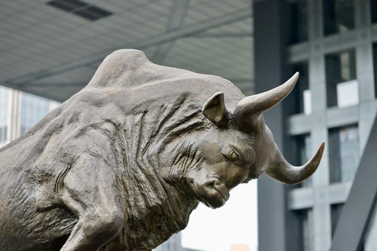 Statue of a bull, head lowered, ready to charge