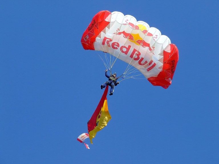 A person skydives under a "Red Bull" parachute. (WikimediaImages/Pixabay)