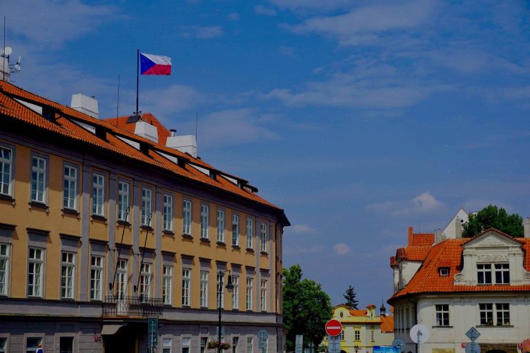 Czech Republic flag on top of building in Prague (R M/Unsplash)
