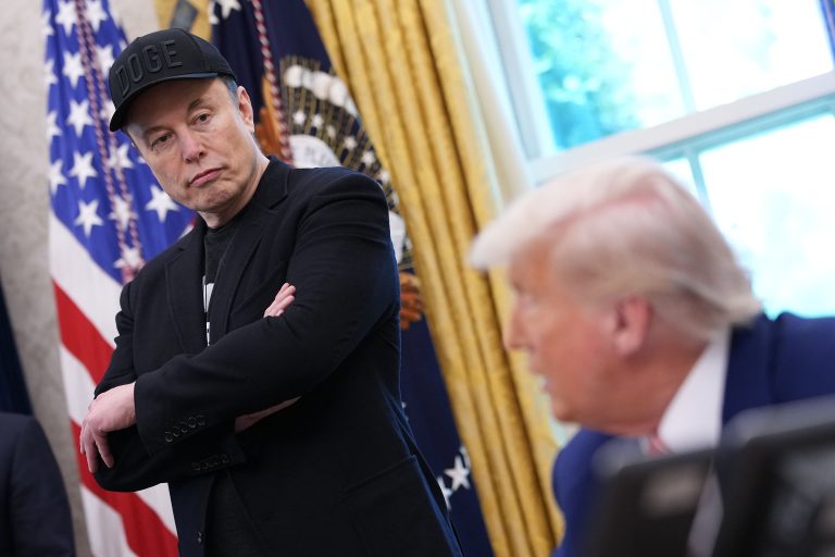 Tesla CEO Elon Musk listens as U.S. President Donald Trump speaks to reporters in the Oval Office of the White House on May 30, 2025