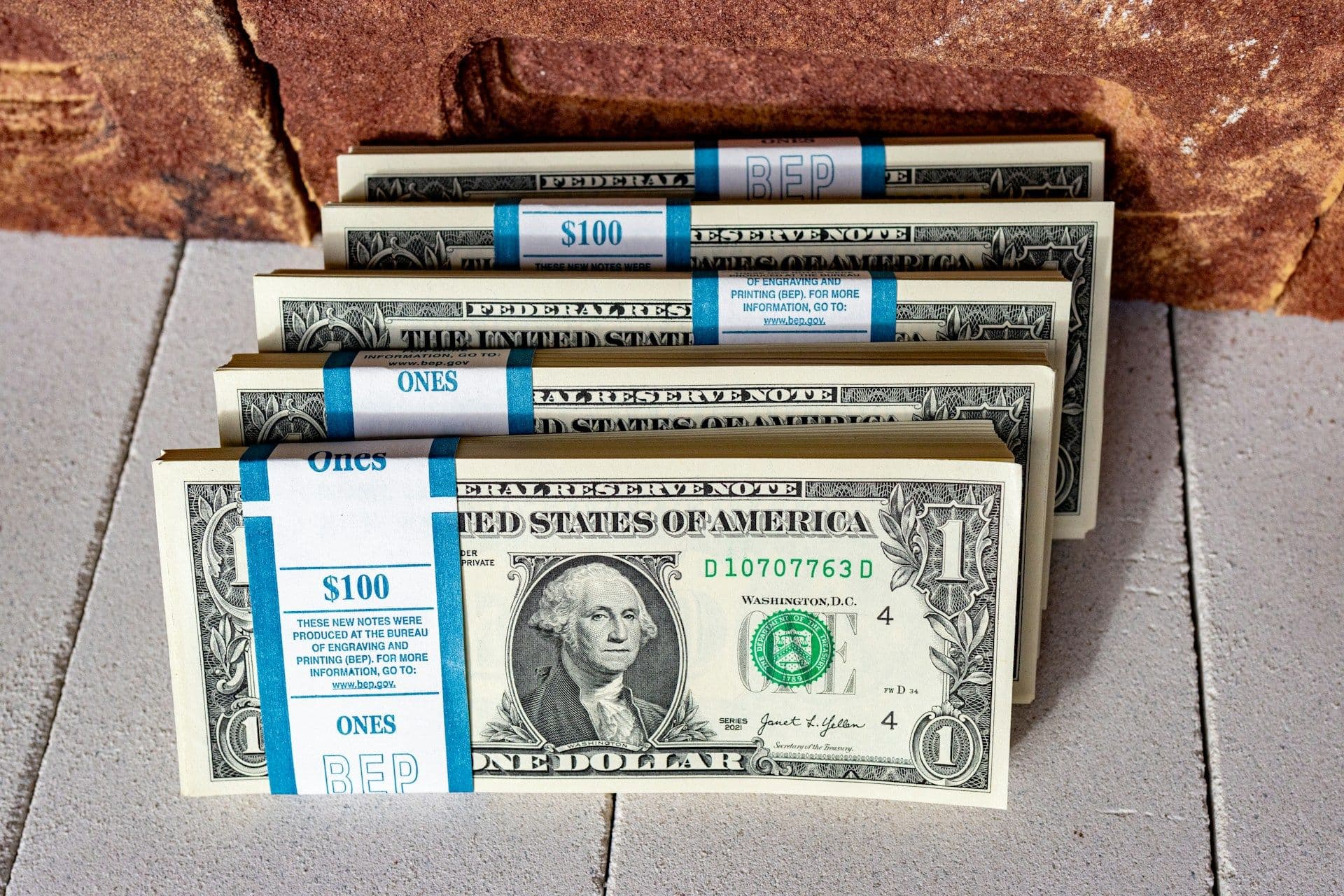 Stacks of $1 bills (Marek Studzinski/unsplash)