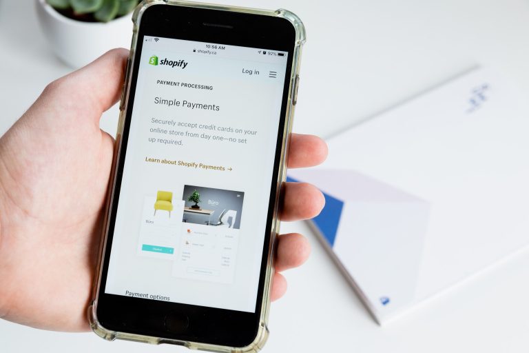 Shopify app screen for merchants displayed on a mobile phone. (Roberto Cortese/Unsplash)