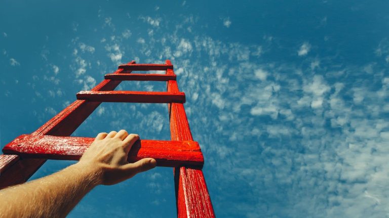 Looking up a wooden ladder toward the sky.