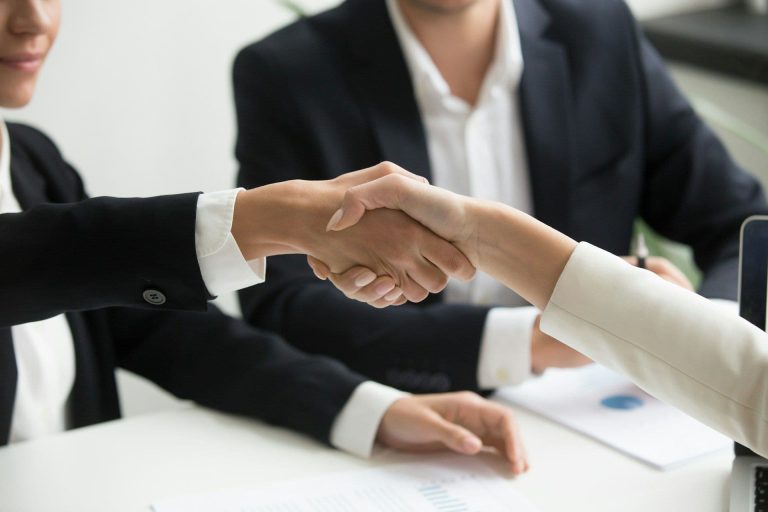 Business deal handshake (Radission US/Unsplash)