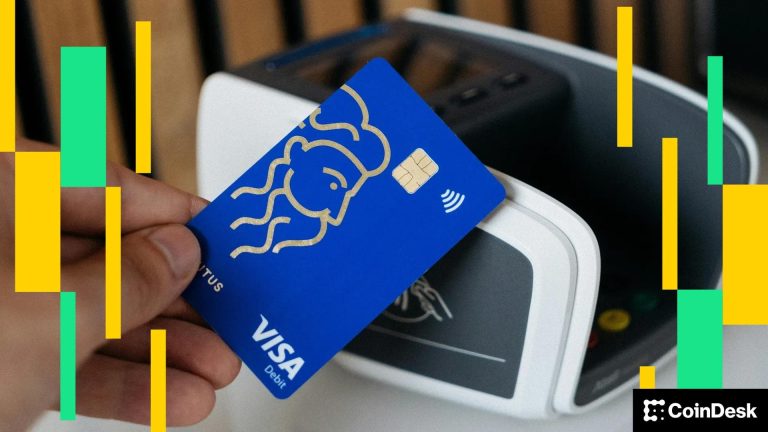 A Visa card being held to next to a payment terminal. (CardMapr.nl/Unsplash)